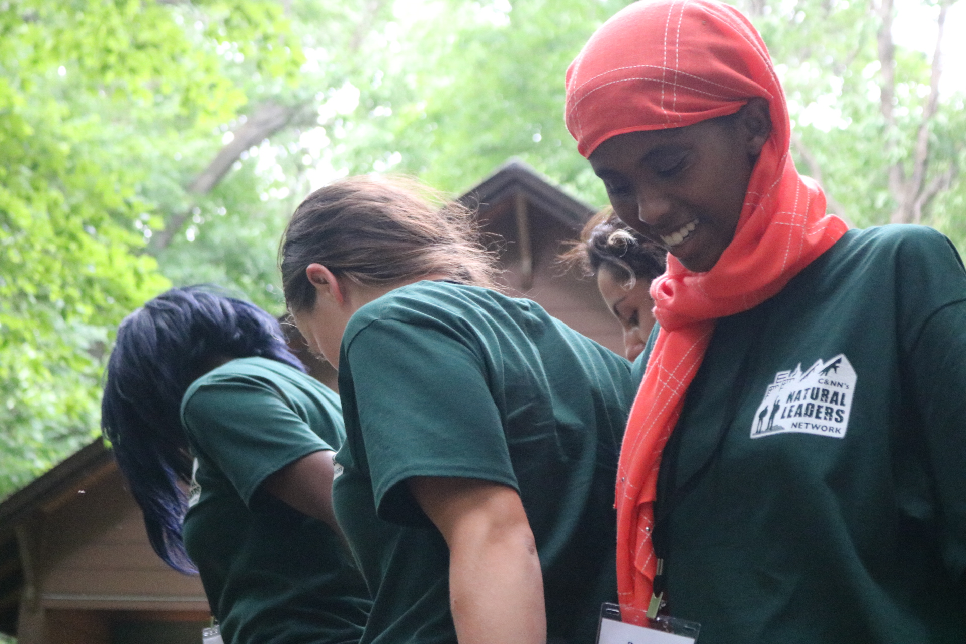 a group of youth holding hands completing an activity together